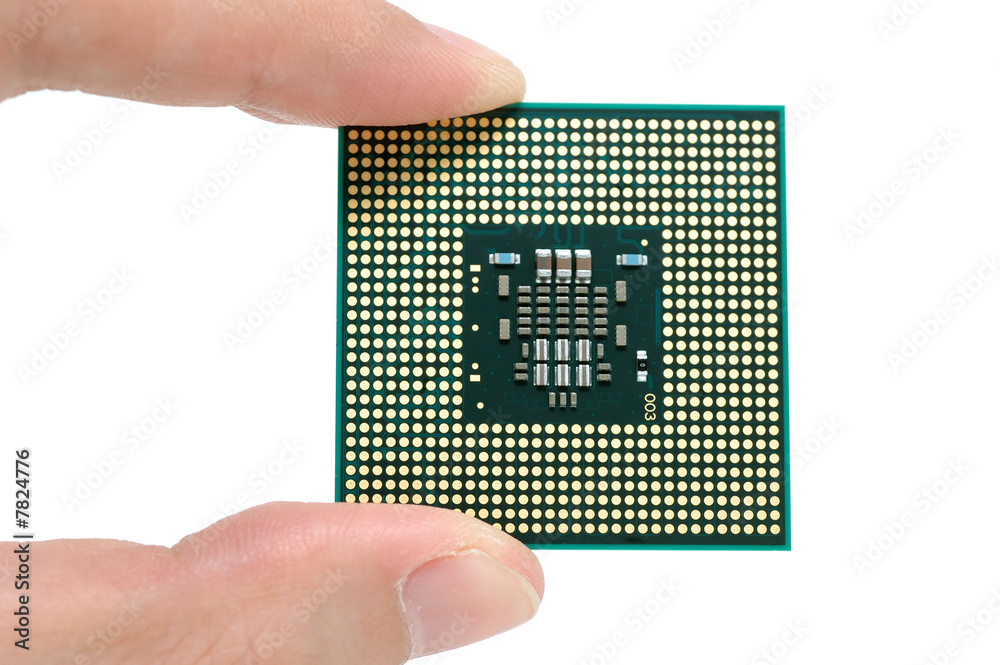 Fingers holding a CPU