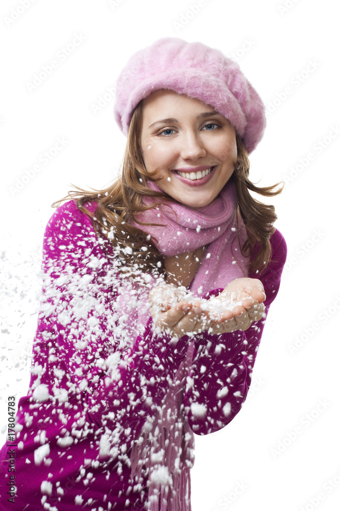 Woman blow snowflakes from hands