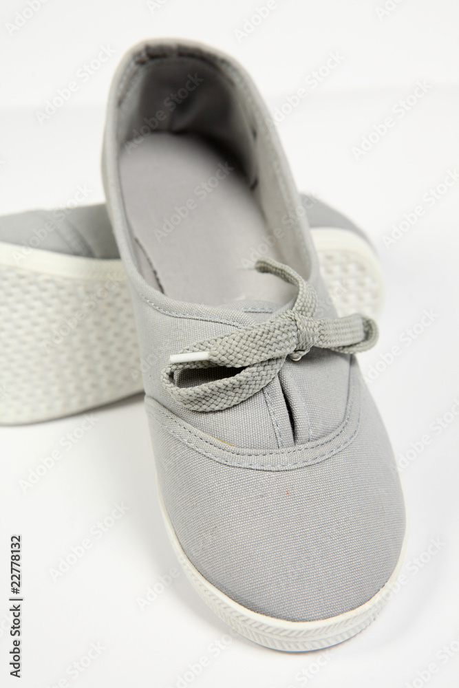 a pair of grey women shoes and white background