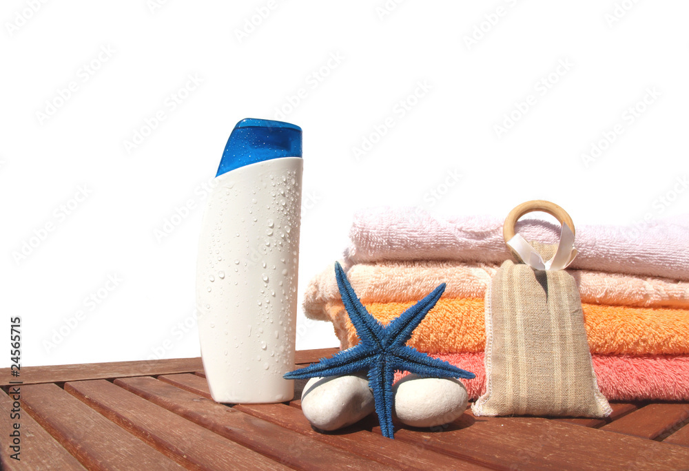 Beach concept with lotion and towels