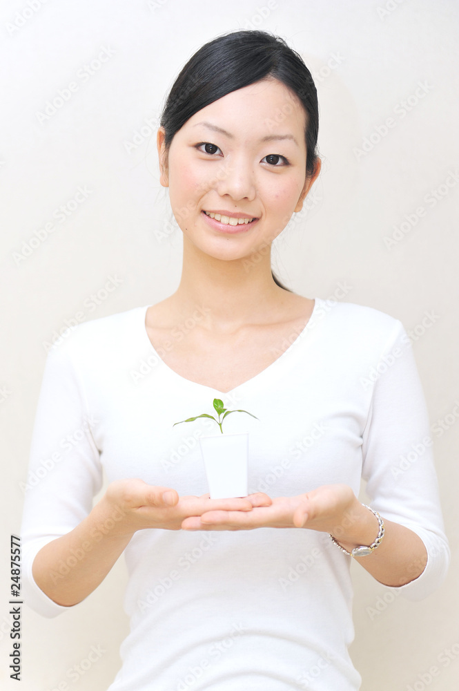 japanese girl holding a small plant