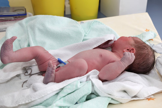 Newborn baby on table at hospital