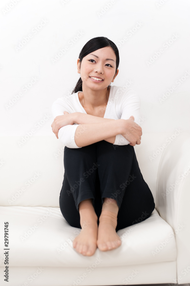 beautiful asian woman sitting on the sofa