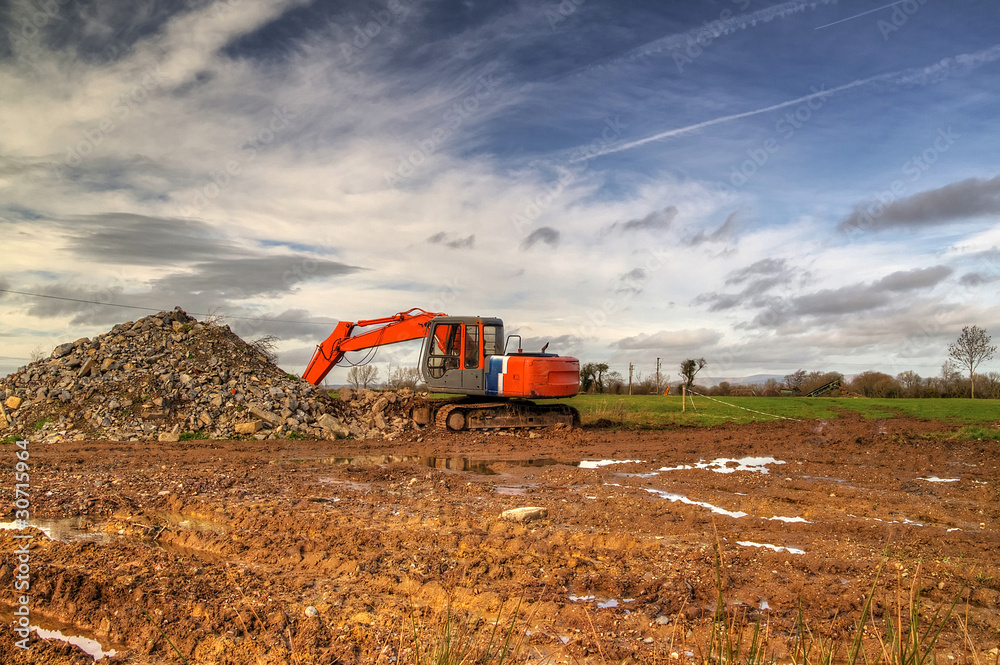 Orange excavator on irish field - HDR