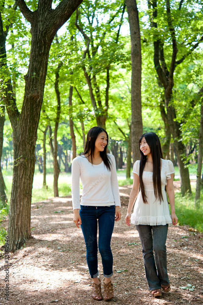 beautiful asian women walking in the forest