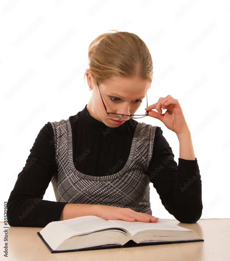 Strict girl reading a book on a white background