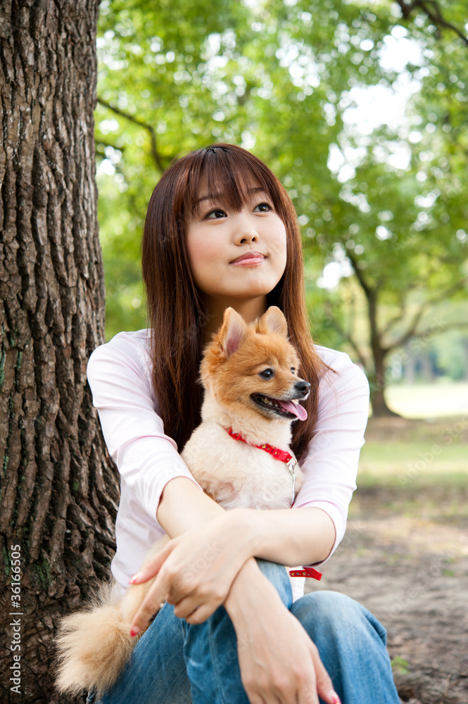 公园里有狗的迷人亚洲女人