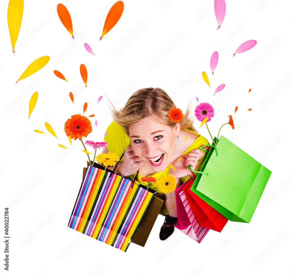 Happy blond girl with shopping bags in spring concept.