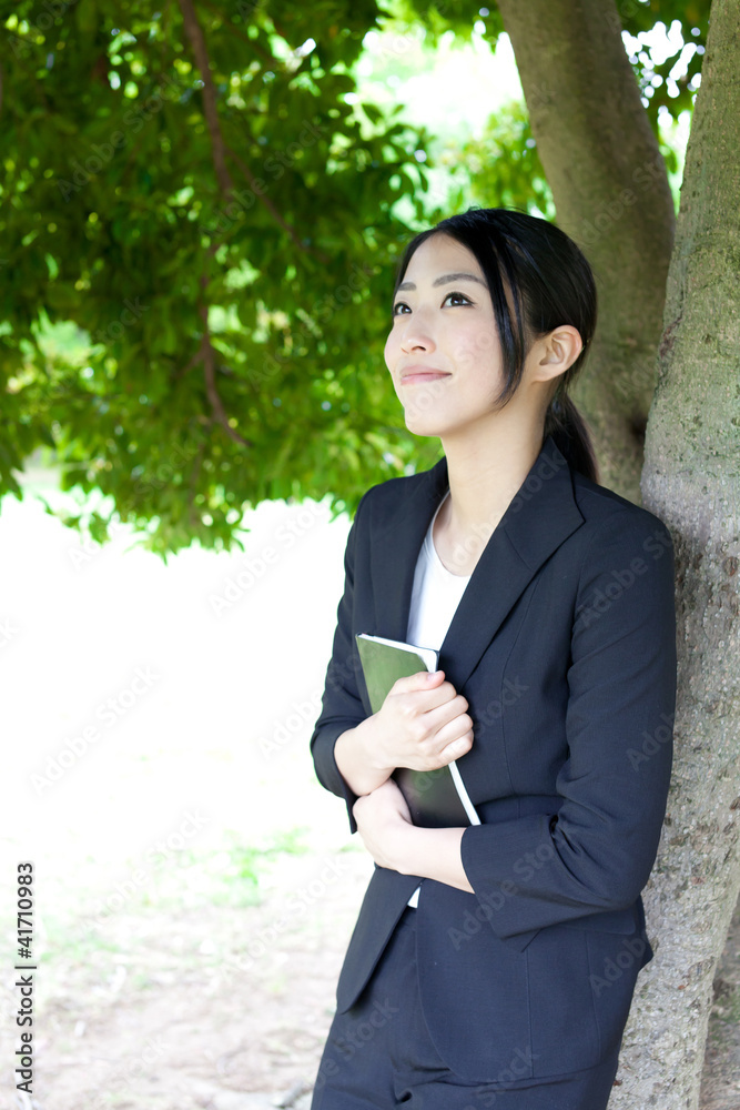asian businesswoman relaxing in the park