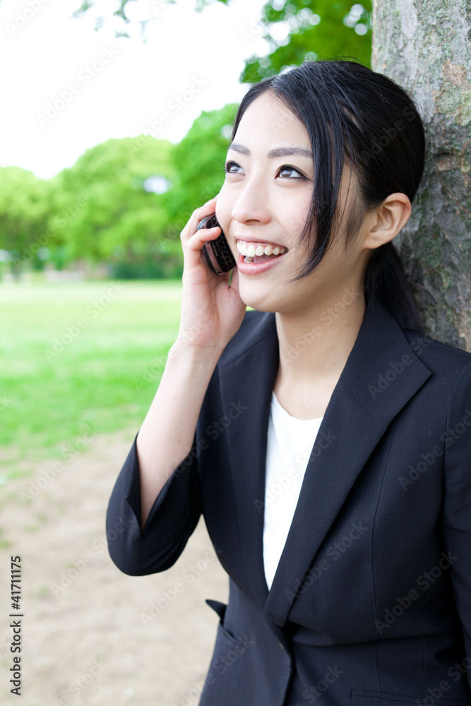 asian businesswoman talking in the park