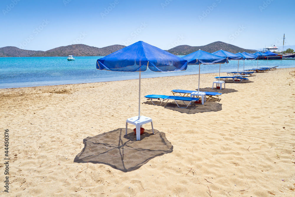 Blue parasols at Aegean Sea of Greece