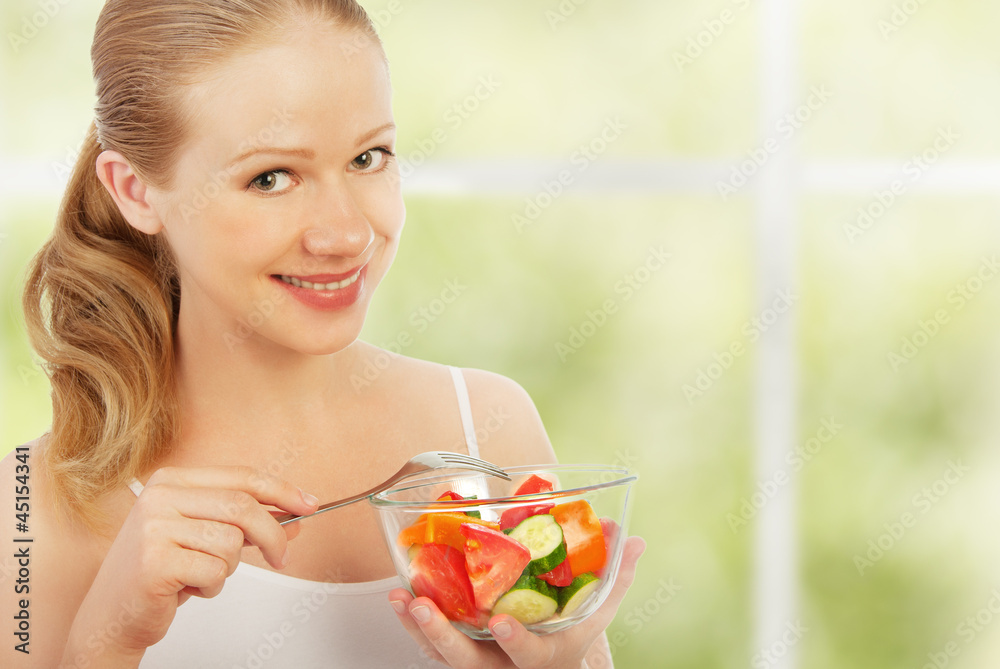 年轻健康女性吃蔬菜沙拉