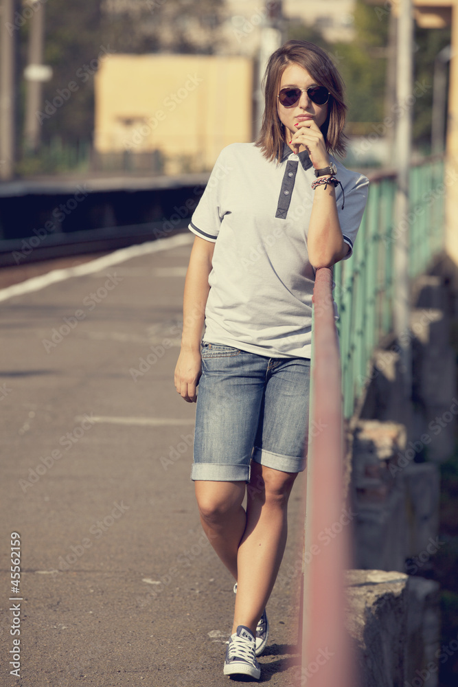 Hipster girl at railways platform.