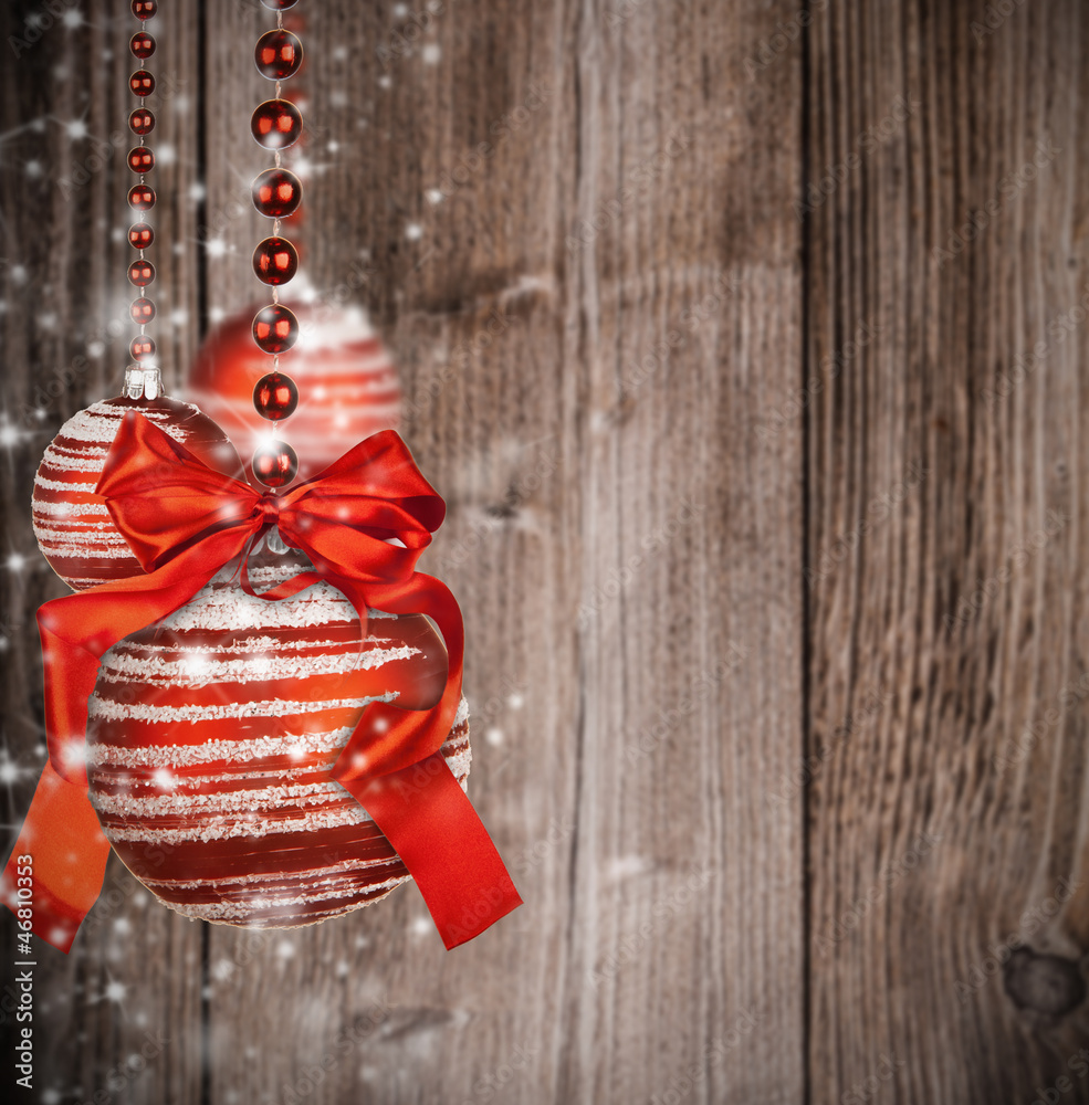  Christmas theme with red glass balls on blur wooden texture