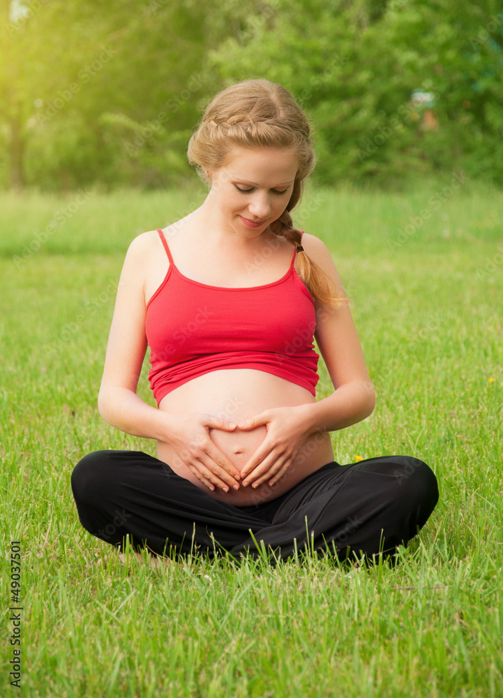 pregnant woman is resting and relaxing on nature