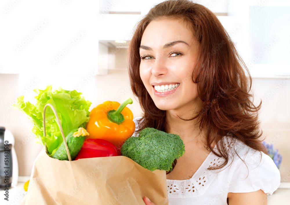 购物袋里有蔬菜的快乐年轻女人