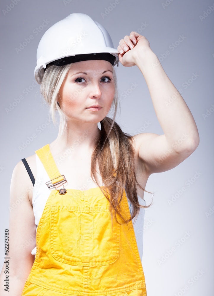 Young woman as a construction worker