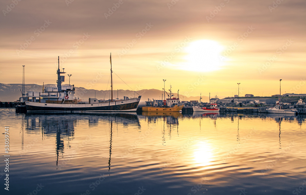 Ships lying in the harbor of Husavik at sunset, Iceland