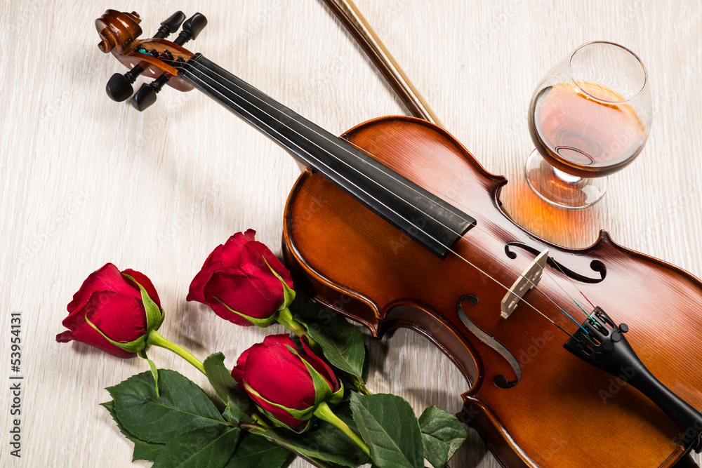 Violin, rose, glass of champagne and music books