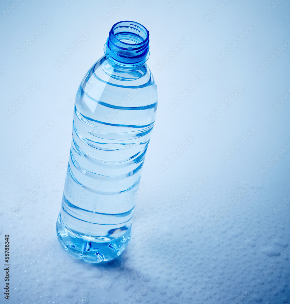 湿蓝色背景的塑料水瓶