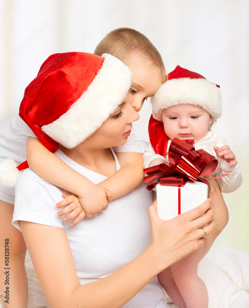 happy family mother and children with gift  in Christmas hats