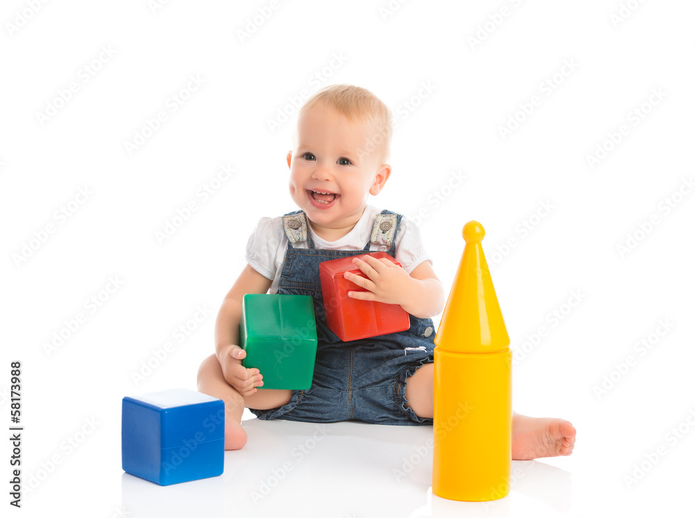 happy cheerful child playing with blocks cubes isolated on white