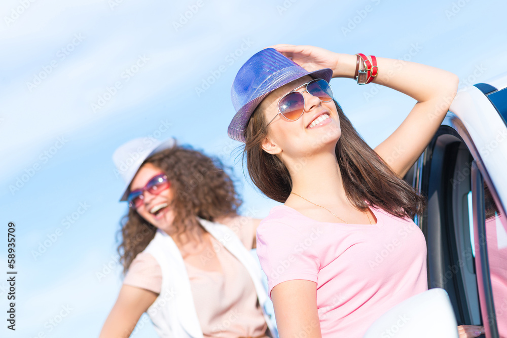 Two attractive young women wearing sunglasses