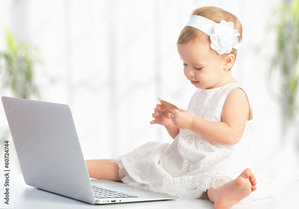 带笔记本电脑和信用卡在网上购物的女婴