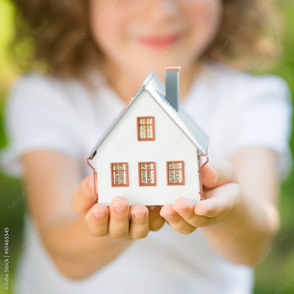 Child holding house