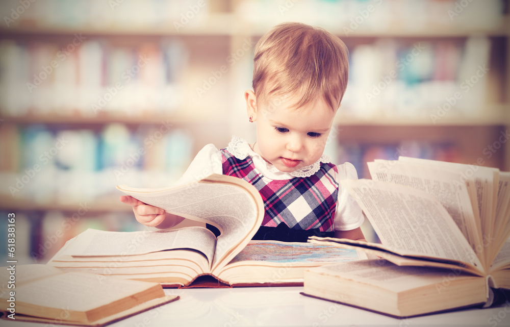 快乐的女婴在图书馆看书