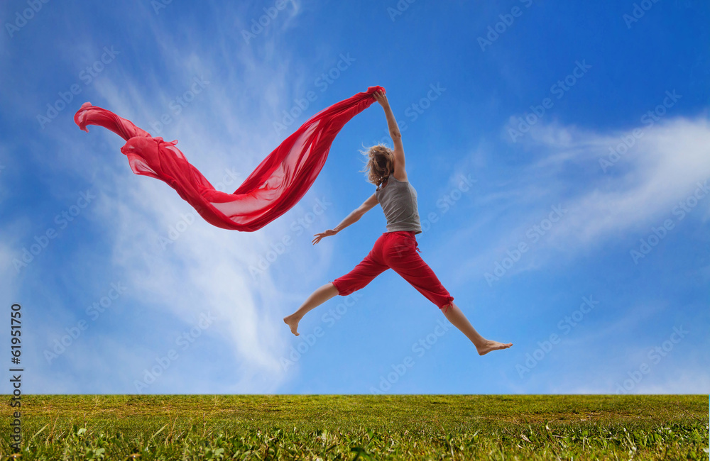 happy girl jumping with red fabric