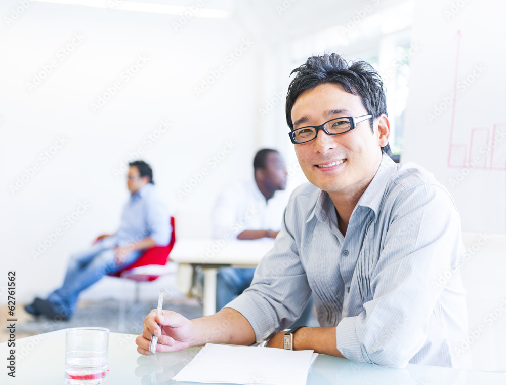 Cheerful Asian Businessman Working in Office