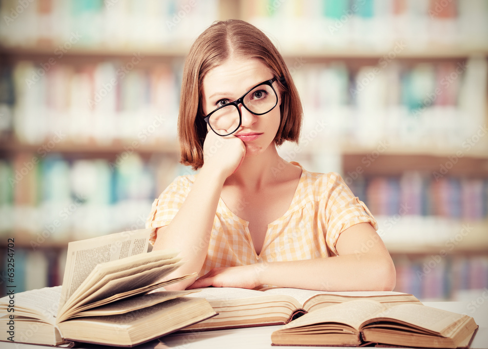 戴眼镜看书的疲惫有趣的女学生