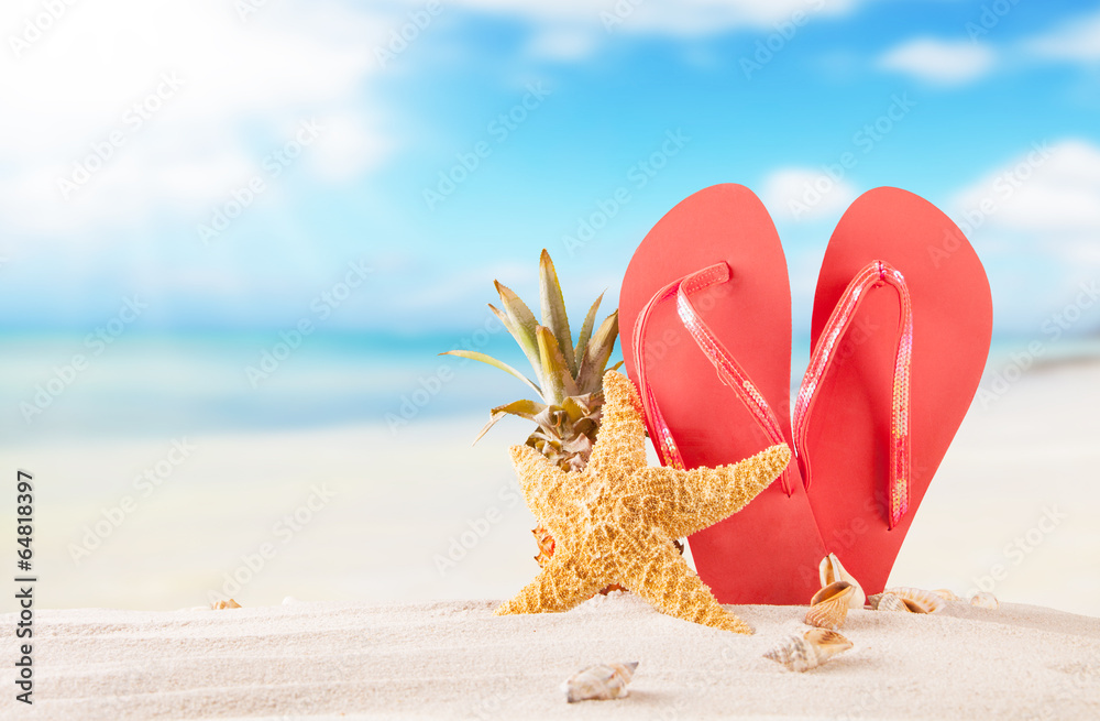 Summer beach with red sandals and shells