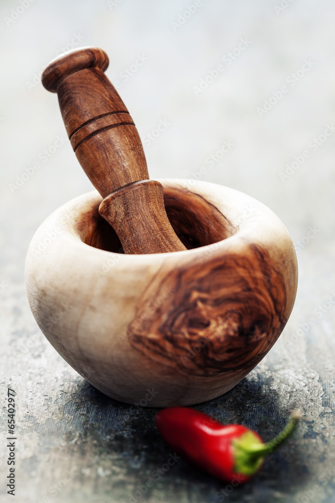 Wooden Mortar and Pestle and chilli peppers