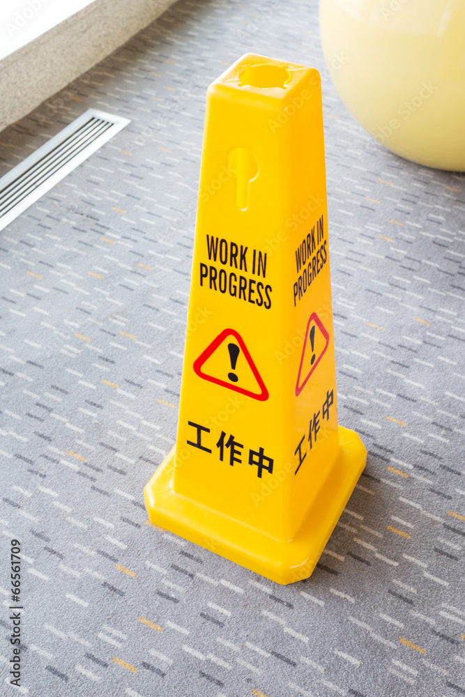 Yellow cone, work in progress signs.