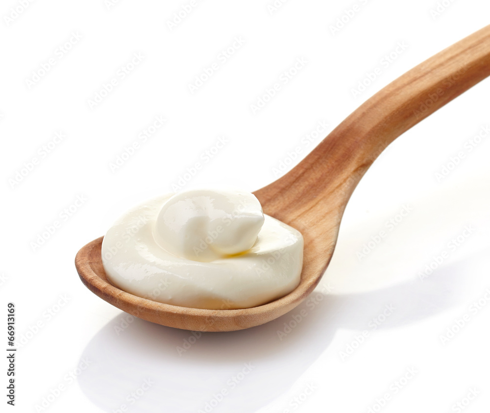 cream in a wooden spoon