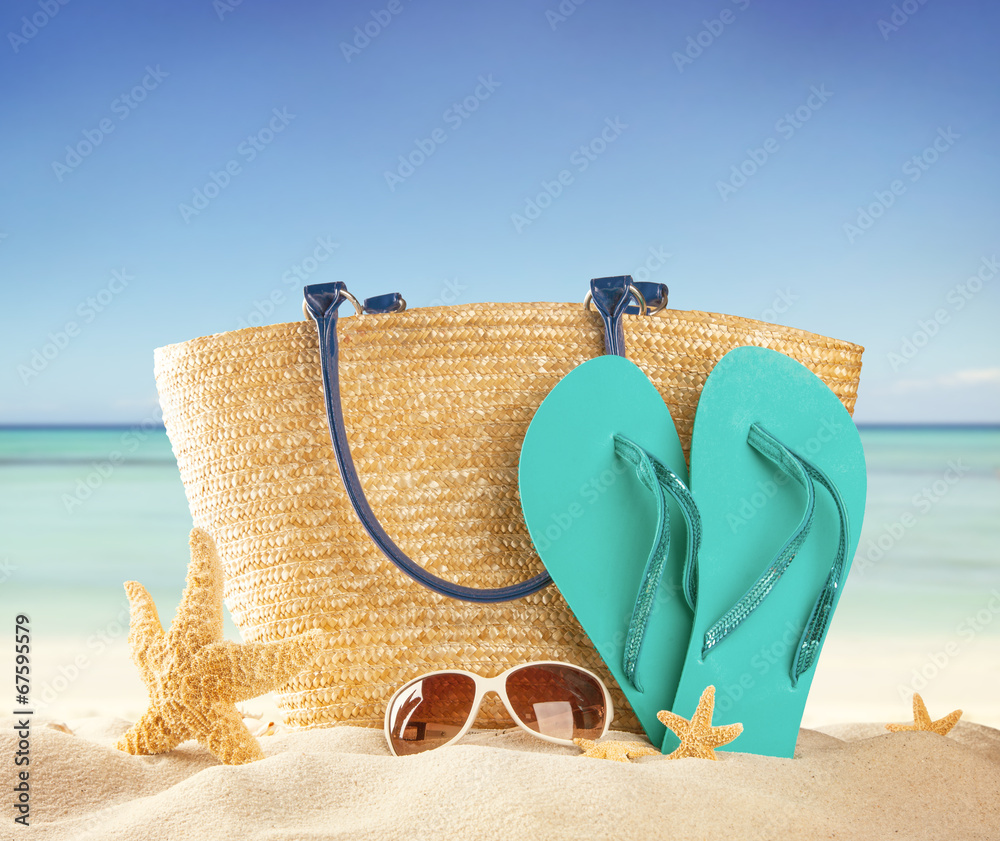 Sandy beach with accessories and blur sea