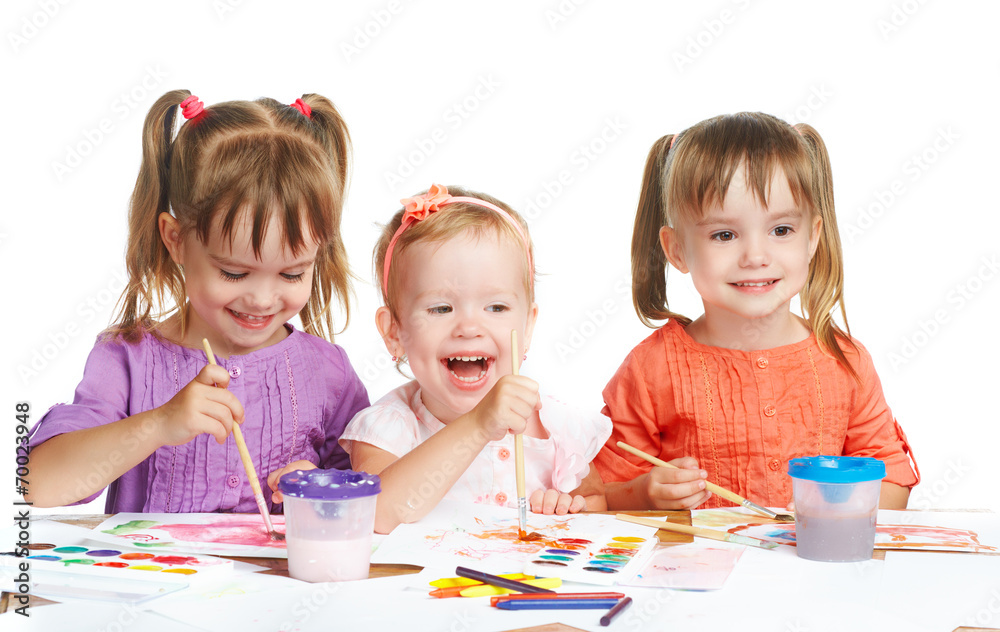 happy little girl in kindergarten draw paints