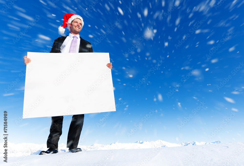 圣诞商人在山顶上举着空白牌