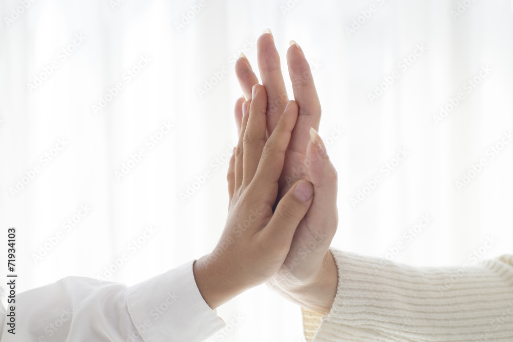 Mother and child with hands together