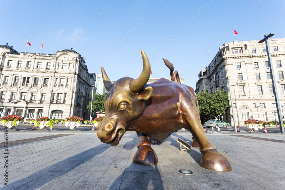 Copper Bull statue on the modern city  street of shanghai.
