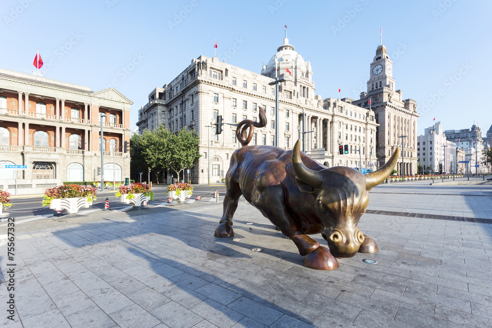 Copper Bull statue on the modern city  street of shanghai.