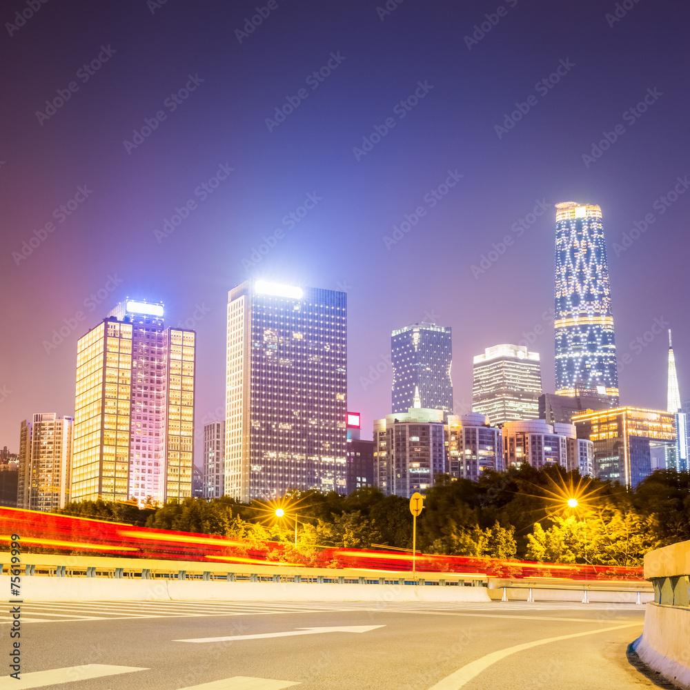 road with modern buildings at night