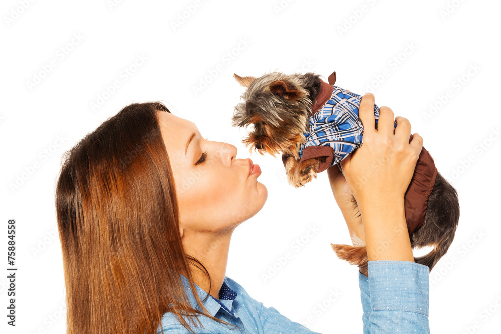 Beautiful woman kissing brown Yorkshire Terrier