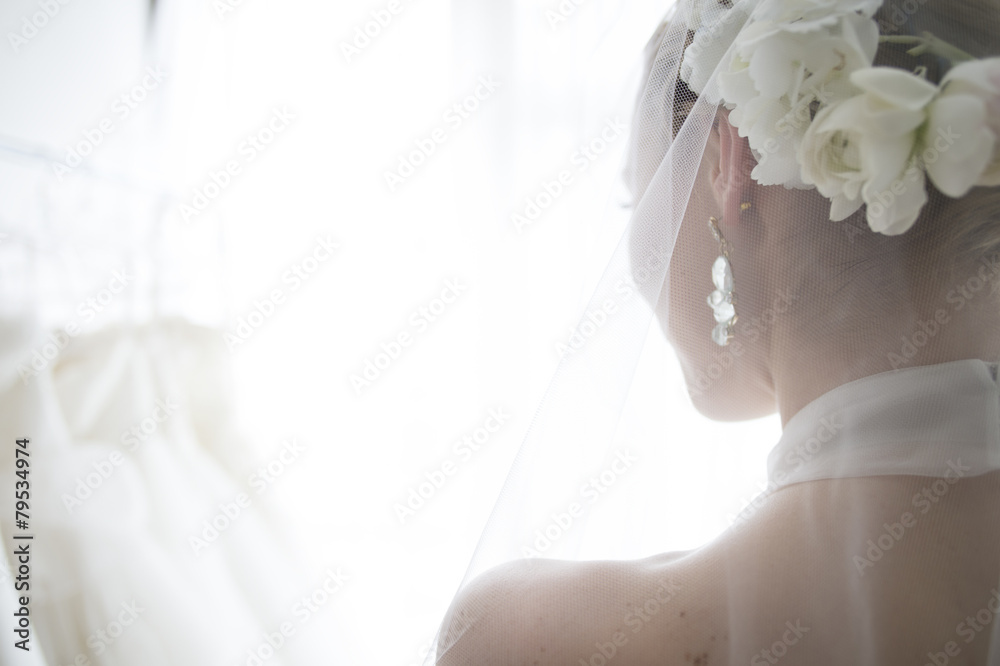 The bride wears a white flower in her hair