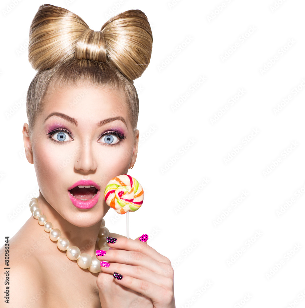 Beauty fashion model girl eating colourful lollipop