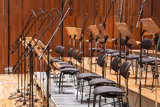 Orchestra stage with chairs and microphone in row