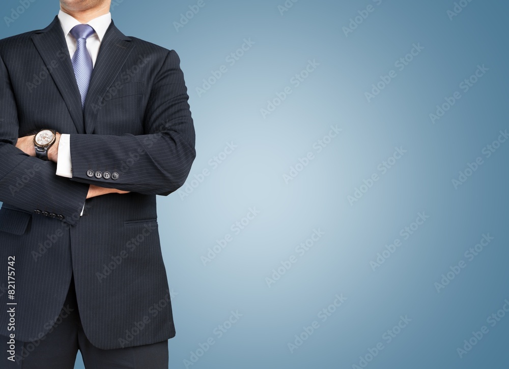 Business. Man in suit on a concrete wall background