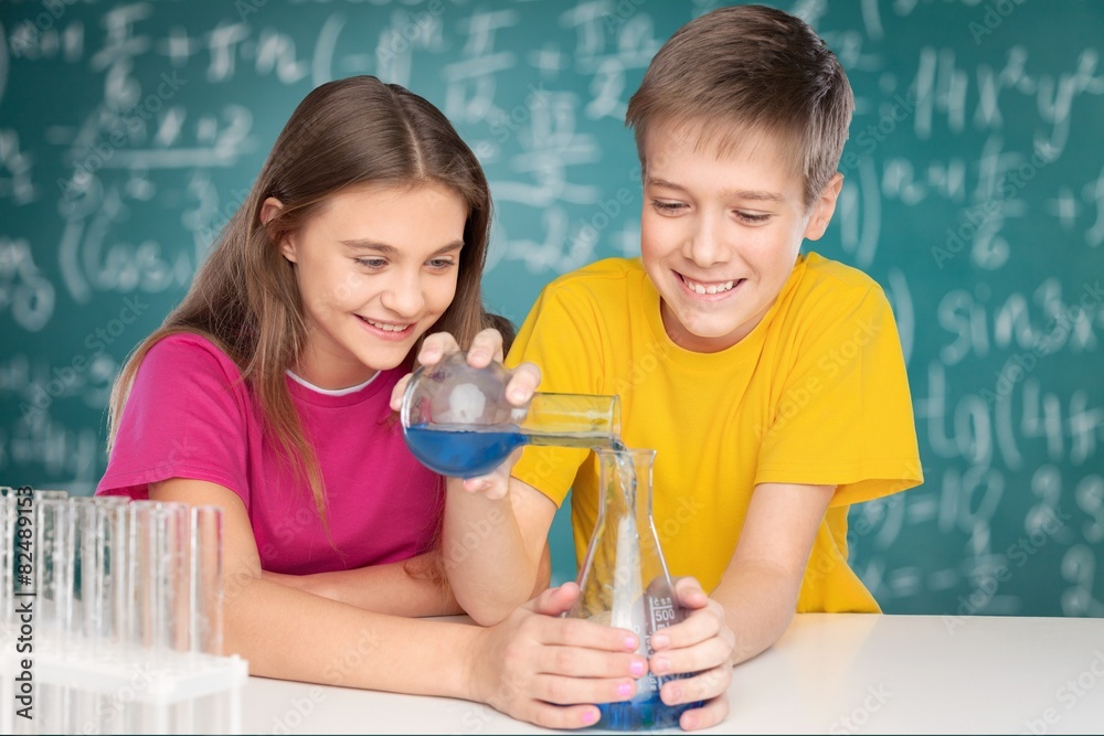 Project. Young school kids doing a chemistry experiment with the